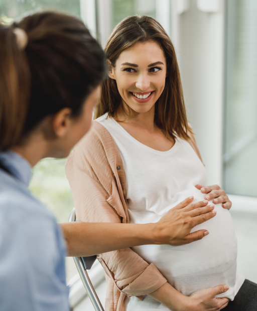 Pregnant woman smiling during an OB-GYN consultation